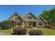 Craftsman-style home with stone accents, lush landscaping, and a well-maintained lawn at 20 Rivercreek Xing, Kingston, GA 30145