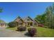 Craftsman-style home featuring stone accents, a manicured lawn, and mature landscaping at 20 Rivercreek Xing, Kingston, GA 30145