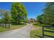 A beautiful house with lush greenery and a long driveway leading to the front entrance at 20 Rivercreek Xing, Kingston, GA 30145