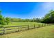 Large, open field with a rustic wooden fence on a sunny day at 20 Rivercreek Xing, Kingston, GA 30145