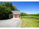 A two-car garage with a well-manicured lawn and fenced pasture in the background at 20 Rivercreek Xing, Kingston, GA 30145