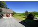 A two-car garage with a wide driveway leading to a large, fenced pasture at 20 Rivercreek Xing, Kingston, GA 30145