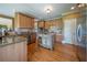 Beautiful kitchen featuring wooden cabinets, stainless steel appliances, granite countertops, and a center island at 20 Rivercreek Xing, Kingston, GA 30145