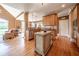 Modern kitchen featuring wooden cabinets, stainless steel appliances, a center island, and hardwood floors at 20 Rivercreek Xing, Kingston, GA 30145