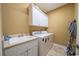 Bright laundry room with modern washer and dryer and built-in cabinets at 20 Rivercreek Xing, Kingston, GA 30145