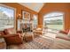 Serene living room boasting a stone fireplace, comfortable seating, and expansive windows offering picturesque outdoor views at 20 Rivercreek Xing, Kingston, GA 30145