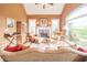 Relaxing living room with a cozy stone fireplace, comfortable seating, and bright windows offering beautiful views at 20 Rivercreek Xing, Kingston, GA 30145