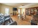 Inviting living room featuring brown leather seating, custom bookshelves, and tile flooring at 20 Rivercreek Xing, Kingston, GA 30145