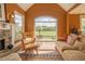 Inviting living room featuring a stone fireplace, large windows with scenic views, and comfortable seating arrangement at 20 Rivercreek Xing, Kingston, GA 30145