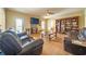 Open living room with tile floor, leather sofas, and built in bookshelves at 20 Rivercreek Xing, Kingston, GA 30145