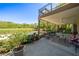 Inviting covered patio featuring comfortable seating, ceiling fan, and views of the pool and backyard at 20 Rivercreek Xing, Kingston, GA 30145