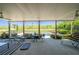 Relaxing covered patio featuring comfortable seating, ceiling fans, and scenic views of the pool and backyard at 20 Rivercreek Xing, Kingston, GA 30145
