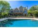 Beautiful in-ground pool with stone surround and lush landscaping, offering a private retreat at 20 Rivercreek Xing, Kingston, GA 30145