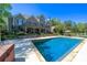 Sparkling in-ground pool with stone surround and manicured landscaping, perfect for summer fun at 20 Rivercreek Xing, Kingston, GA 30145