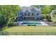 Back of the house features a large in-ground pool, lush landscaping, and a fenced-in yard at 20 Rivercreek Xing, Kingston, GA 30145