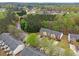 Aerial perspective of townhomes in a community surrounded by mature trees and greenery at 3355 Waldrop Trl, Decatur, GA 30034