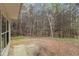 Backyard featuring a concrete patio surrounded by natural landscape and trees at 3355 Waldrop Trl, Decatur, GA 30034