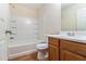 Bright bathroom featuring a tub with shower, a white sink, and wood-finish vanity with storage at 3355 Waldrop Trl, Decatur, GA 30034