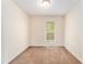 This bedroom features neutral walls, brown carpeting, and a window providing natural light at 3355 Waldrop Trl, Decatur, GA 30034