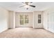 Bright bedroom featuring carpet, a ceiling fan, and windows at 3355 Waldrop Trl, Decatur, GA 30034