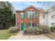 Charming two-story brick townhouse with green shutters and a well-maintained front yard at 3355 Waldrop Trl, Decatur, GA 30034