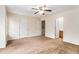 Large main bedroom with carpet, ceiling fan, and two entry doors at 3355 Waldrop Trl, Decatur, GA 30034