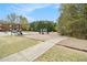 Community playground featuring slides and benches surrounded by trees and green spaces at 3355 Waldrop Trl, Decatur, GA 30034