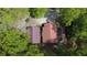 Aerial view of a house with a barn, surrounded by lush green trees, showcasing the property's natural setting at 5 Colonial Club Se Dr, Acworth, GA 30102