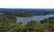 Beautiful aerial view of a lake surrounded by lush green trees, showcasing the property's natural setting at 5 Colonial Club Se Dr, Acworth, GA 30102