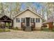 Charming front exterior features symmetrical design, covered entrance, gravel driveway and separate garage at 5 Colonial Club Se Dr, Acworth, GA 30102