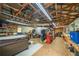 Spacious garage featuring high ceilings, fluorescent lighting, and ample storage and work space at 5 Colonial Club Se Dr, Acworth, GA 30102