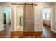 Hallway with wood floors and sliding barn door connecting the other bedrooms at 5 Colonial Club Se Dr, Acworth, GA 30102