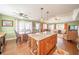 Open kitchen and living area boasts natural light, an eat-in area, hardwood floors and a custom kitchen island at 5 Colonial Club Se Dr, Acworth, GA 30102