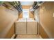 Convenient laundry room with tile flooring and storage shelving at 5 Colonial Club Se Dr, Acworth, GA 30102