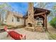 Charming home exterior with a stone fireplace and covered outdoor kitchen, perfect for outdoor gatherings at 5 Colonial Club Se Dr, Acworth, GA 30102