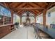Covered outdoor kitchen and dining area with a fireplace and a built-in grill, perfect for outdoor entertaining at 5 Colonial Club Se Dr, Acworth, GA 30102