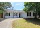 Charming single-story home with a black roof, black shutters, and a well-maintained front yard at 6269 Marbut Farms Rd, Lithonia, GA 30058