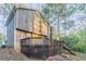The home's backyard with multi-level deck, perfect for entertaining, is surrounded by mature trees at 3094 Calumet Nw Cir, Kennesaw, GA 30152