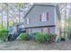 Split-level home featuring neutral siding, red shutters, and exterior staircase at 3094 Calumet Nw Cir, Kennesaw, GA 30152