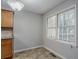 Bright kitchen with window, tile floor, granite countertops, and wood cabinetry at 3094 Calumet Nw Cir, Kennesaw, GA 30152