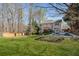 Expansive backyard featuring a pool, deck, mature trees, and lush green lawn at 3823 Briarstone Cv, Snellville, GA 30039