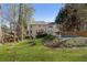 Extensive backyard featuring a pool, deck, mature trees, and lush green lawn at 3823 Briarstone Cv, Snellville, GA 30039