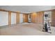 Spacious basement with wood-paneled walls, and multiple doors at 3823 Briarstone Cv, Snellville, GA 30039