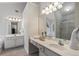 Bright bathroom with dual sinks, vanity, and a soaking tub is designed for relaxation and functionality at 3823 Briarstone Cv, Snellville, GA 30039
