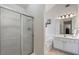 This bathroom has a glass-enclosed shower, soaking tub, and elegant vanity with modern fixtures at 3823 Briarstone Cv, Snellville, GA 30039