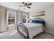 Cozy bedroom with warm ambiance, a wrought iron bed frame, and natural light creates a tranquil retreat at 3823 Briarstone Cv, Snellville, GA 30039