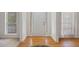 Bright foyer with hardwood floors, a white front door, and sidelight windows for a welcoming entrance at 3823 Briarstone Cv, Snellville, GA 30039