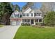 Charming two-story home with a well-manicured lawn, a two-car garage, and a welcoming front porch at 3823 Briarstone Cv, Snellville, GA 30039