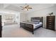Spacious main bedroom with a ceiling fan, natural light, and a cozy sitting area offers a tranquil retreat at 3823 Briarstone Cv, Snellville, GA 30039