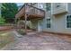 A backyard featuring a raised deck, brick patio, and landscaped retaining wall that enhances the outdoor living space at 4005 Saddlebrook Creek Dr, Marietta, GA 30060